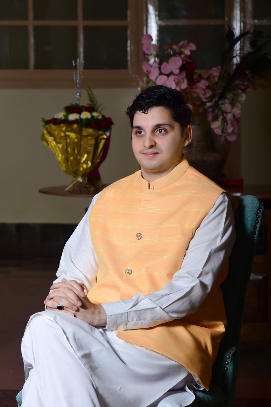 Seated portrait in a saffron Nehru jacket