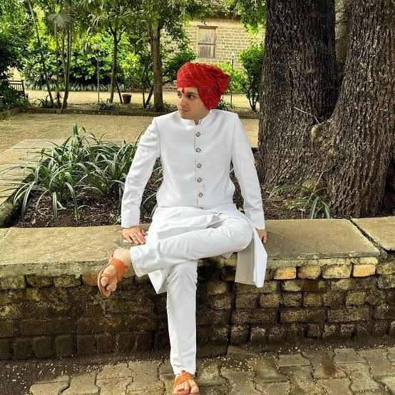 Seated outdoors in white